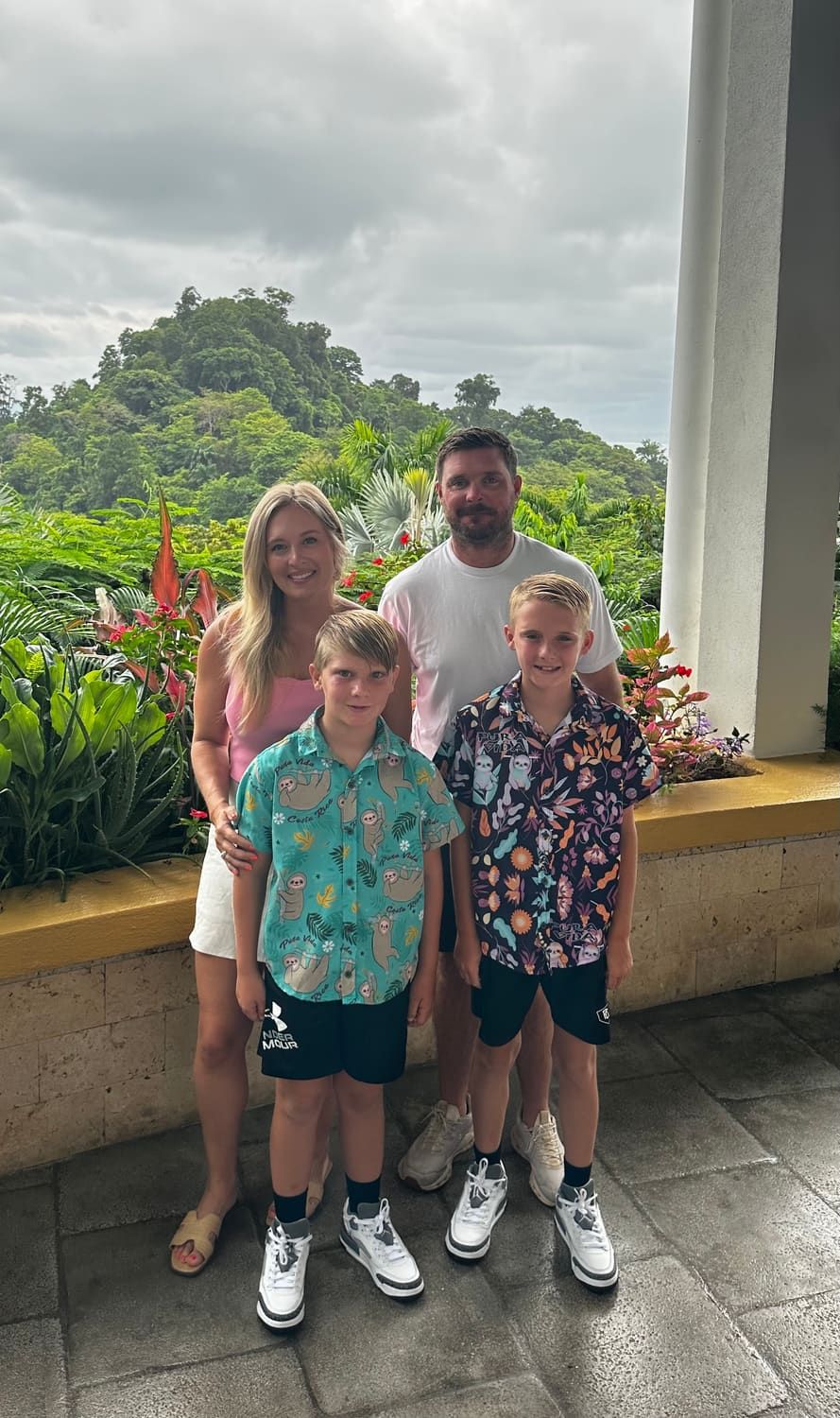 Jessica with her family on a balcony overlooking the rainforest